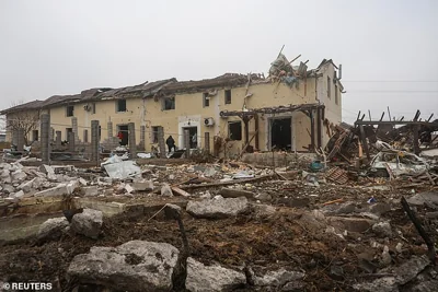 Residents stand next to their house damaged by a Russian missile strike, amid Russia's attack on Ukraine, on the outskirts of Odesa, Ukraine November 28, 2024