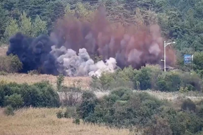 This screen grab taken from video released by the South Korean Defence Ministry and filmed from an undisclosed location in South Korea along the inter-Korean border shows an explosion on a road connecting North and South Korea on October 15, 2024. AFP PHOTO / SOUTH KOREAN DEFENSE MINISTRY