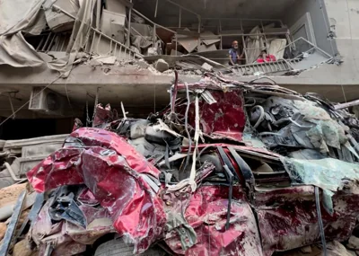 Residents remove the debris from their destroyed balcony at the site of the previous day's Israeli airstrike, in Beirut, Lebanon, Oct. 11. AP-Yonhap