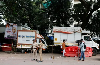 Police officers and media stand at a crime scene where Nationalist Congress Party (NCP) politician Baba Siddique was shot dead in Mumbai, India, October 13, 2024. 