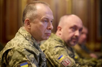 Commander in Chief of the Ukrainian Armed Forces Colonel General Oleksandr Syrskii. He is in combat fatigues and sitting at a table.