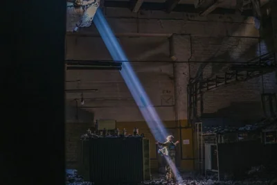 A Ukrainian soldier inside the ruined Azovstal steel plant stands under a sunlight ray in his shelter in Mariupol, 7 May 2022