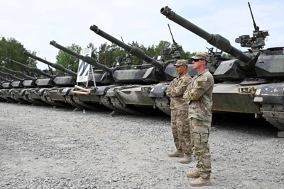 US soldiers stand in front of military tanks at the United States Army military training base in Grafenwoehr, southern Germany