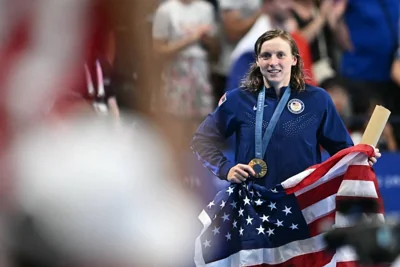 Gold medallist US' Katie Ledecky celebrates during the podium ceremony of the women's 1500m freestyle swimming event during the Paris 2024 Olympic Games at the Paris La Defense Arena in Nanterre, west of Paris, on July 31, 2024. AFP PHOTO