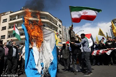 Iranians burn an Israeli flag during a rally marking Quds Day and the funeral of members of the Islamic Revolutionary Guards Corps who were killed in a suspected Israeli airstrike on the Iranian embassy complex in Damascus, Syria last week