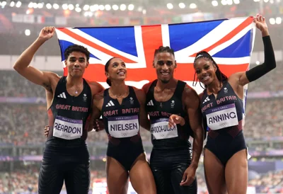 Samuel Reardon, Laviai Nielsen, Alex Haydock-Wilson and Amber Anning celebrate after winning a bronze medal in the 4 x 400m relay mixed final (Martin Rickett/PA)