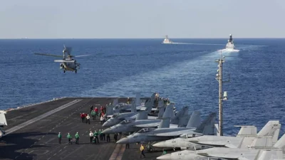  In this handout photo provided by the US Navy, The aircraft carrier USS Abraham Lincoln (CVN 72) transits the Strait of Hormuz as an MH-60S Sea Hawk helicopter from the Nightdippers of Helicopter Sea Combat Squadron (HSC) 5 lifts off from the flight deck.