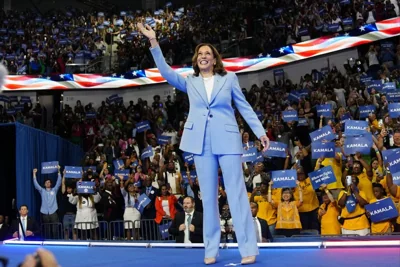 Vice President Kamala Harris waves during a campaign rally, July 30, 2024, in Atlanta.