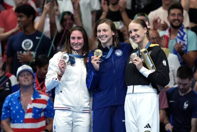 Katie Ledecky (centre) has now won eight Olympic gold medals (Martin Rickett/PA)
