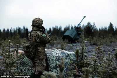 Gun line section commander Staff Sergeant Rai uses a radio to speak to Archer crews from 19th Regiment Royal Artillery NATO live fire drills in Finland called Exercise Dynamic Front