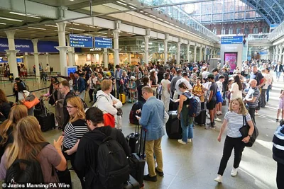 Passengers queue at the Eurostar terminal at St Pancras station in central London