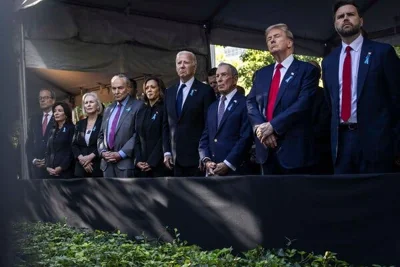 President Biden, Vice President Kamala Harris, former President Donald J. Trump, Senator JD Vance and other political figures stand at a memorial, some folding their hands.