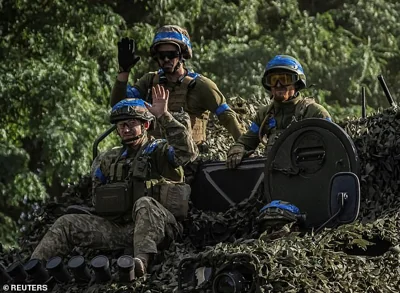 Ukrainian service members ride an Armoured Personnel Carrier, amid Russia's attack on Ukraine, near the Russian border in Sumy region on August 11