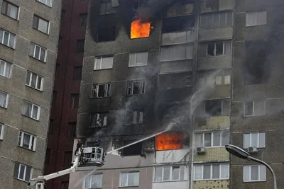 Firefighters work to extinguish a fire in an apartment building after a Russian missiles and drone attack in Kyiv, February 7, 2024