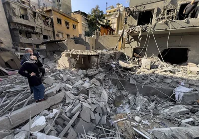 People survey the damage of Israeli air strikes on central Beirut, 23 November, 2024