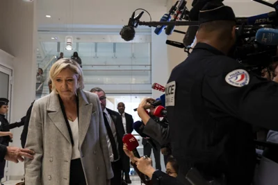 Marine Le Pen walks past the media