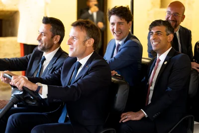 French President Emmanuel Macron driving a golf car with British Prime Minister Rishi Sunak, President of the European Council Charles Michel and Canadian Prime Minister Justin Trudeau during the G7 summit in Italy