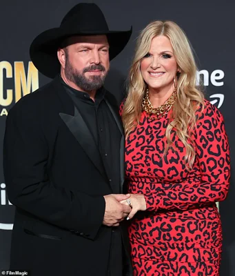 Garth Brooks has been sued by a makeup artist who worked for his wife of nearly two decades, Trisha Yearwood; Brooks and Yearwood are pictured in 2023