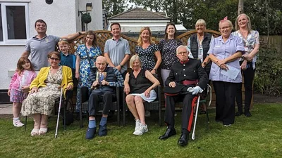 Mr Tinniswood  died at the Hollies Rest Home in Southport, Merseyside, on Monday 'surrounded by music and love'. He is pictured with his family and care home workers