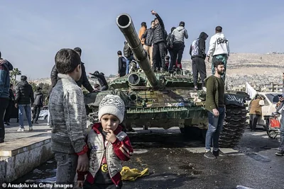 People celebrate the collapse of 61 years of Baath Party rule as they gather at Umayyad Square after armed groups, opposing Syria's Bashar al-Assad regime, take control in Damascus, Syria on December 9, 2024