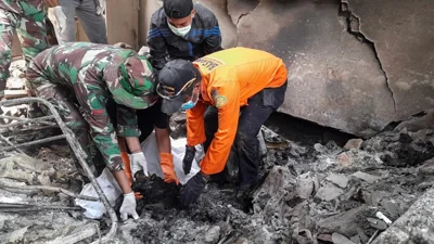 Indonesia’s Search and Rescue Agency (BASARNAS) rescuers search for victims of the Lewotobi Laki-Laki volcano eruption in East Flores