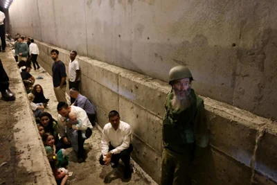 People take shelter during an air raid siren after Iran fired a salvo of ballistic missiles, amid cross-border hostilities between Hezbollah and Israel, in central Israel Oct. 1. Reuters-Yonhap