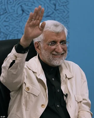 Iran's former top nuclear negotiator Saeed Jalili waves to media while registering his name as a candidate for the June 28 presidential election at the Interior Ministry in Tehran, Iran, Thursday, May 30, 2024