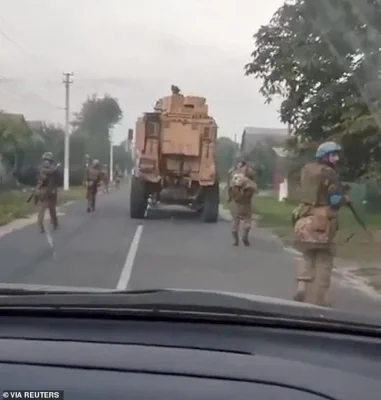 Members of the Ukrainian army patrol in Plekhovo, Kursk Region, Russia in this screengrab obtained from a video released on August 13, 2024