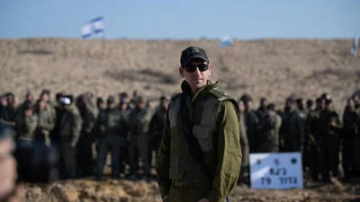 IDF Col. Amir Ofri with troops in the Netzarim Corridor that splits Gaza in half.