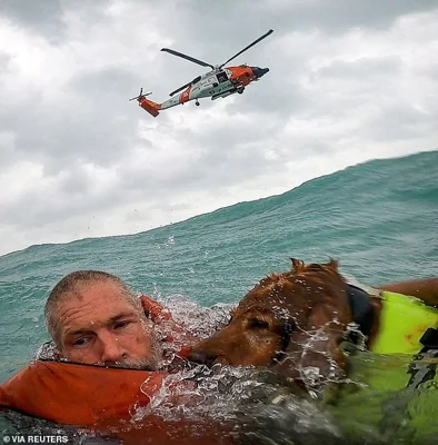 A U.S. Coast Guard Air Station crew rescues a man and his dog during Hurricane Helene after his sailboat became disabled and started taking on water off Sanibel Island, Florida, U.S. September 26, 2024