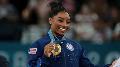 Gold medalist Simone Biles of Team United States poses on the podium during the Artistic Gymnastics Women's All-Around Final medal ceremony on day six of the Olympic Games Paris 2024 at Bercy Arena on Aug. 1, 2024 in Paris.