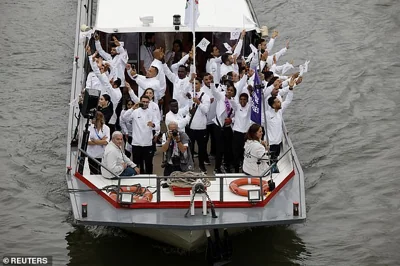 Athletes of the Refugee Olympic team arrive on the Seine