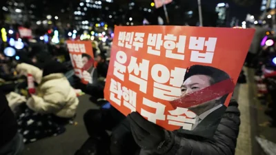 Protesters hold banners during a rally to demand South Korean President Yoon Suk Yeol's impeachment outside the National Assembly in Seoul, South Korea, Friday, Dec. 13, 2024