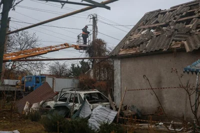 A man works on power lines. 