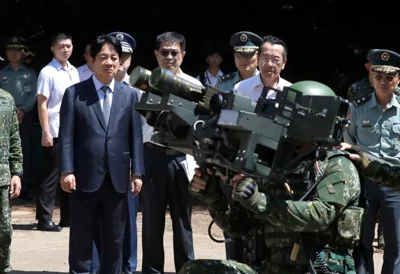 Taiwan President Lai Ching-te, front left, listens to a briefing during a multiple stinger missile launcher demonstration as he visits to inspect Taiwanese military at a military base on the outlying Penghu Island, Taiwan, Sept. 6. AP-Yonhap