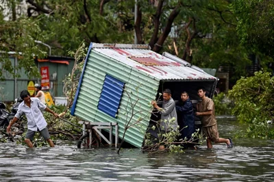 TRAIL OF DESTRUCTION Men collect debris on a flooded street after Super Typhoon Yagi hit Hai Phong on Sept. 8, 2024. AFP PHOTO