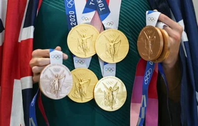 Four time Tokyo 2020 Gold medallist Emma McKeon shows off her medal haul of 4 Gold and 3 Bronze medals during a press conference at the Main Press Centre during the Tokyo Olympic Games.