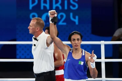 Paris 2024 Olympics - Boxing - Women's 66kg - Semifinal - Roland-Garros Stadium, Paris, France - August 06, 2024. Referee raises the arm of Imane Khelif of Algeria after winning her fight against Janjaem Suwannapheng of Thailand. REUTERS/Maye-E Wong TPX IMAGES OF THE DAY