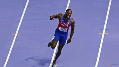 Lyles wins 100 metres gold by a whisker