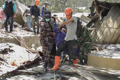 Members of a rescue team carry away body bags containing deceased people at Klatanlo village, in East Flores Regency, East Nusa Tenggara, on November 4, 2024, after Mount Lewotobi Laki-Laki erupted overnight. AFP PHOTO