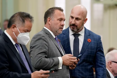 Democrat Adam Gray, of Merced, center, and Republican Heath Flora of Ripon, right, confer during the Assembly session at the Capitol in Sacramento in 2022. Gray has now flipped a Republican House seat in California