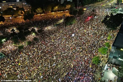 An aerial view of thousands of Israelis gathering with banners to protest against Israeli Prime Minister Benjamin Netanyahu in Tel Aviv on Saturday night