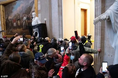 Donald Trump supporters face off with police inside the US Capitol during a protest meant to stop the transfer of power to Joe Biden, on January 6, 2021