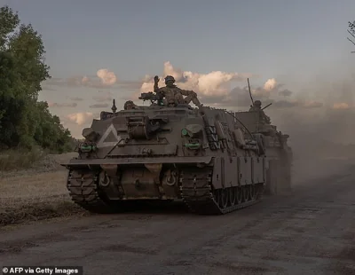 Ukrainian servicemen operate an armoured military vehicle in the Sumy region, near the border with Russia, on August 12, 2024