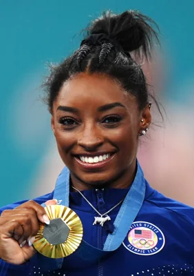 Biles with her gold medal and sporting a silver goat necklace (Mike Egerton, PA)