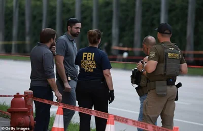 Law enforcement personnel investigate the area around Trump International Golf Club after an apparent assassination attempt