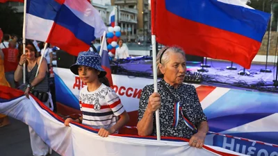 Russians living in Cyprus hold their national flags to celebrate Russia Day in Nicosia, Cyprus