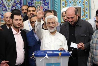  Iranian hardline presidential candidate Saeed Jalili, center, waves after casting his vote at a polling station during the presidential election in Tehran, Iran, June 28. EPA-Yonhap