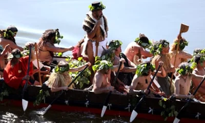 Māori warriors paddle waka down the Waikato river towards Taupiri Maunga during the tangi, or funeral rite, for the Māori King Tuheitia Pootatau Te Wherowhero VII