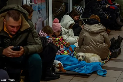 People with their pet take shelter inside a metro station during a Russian military strike, amid Russia's attack on Ukraine, in Kyiv, Ukraine November 28, 2024